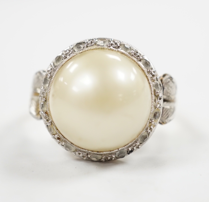 A yellow metal, simulated mabe pearl and paste set cluster ring, size O, gross weight 4.6 grams.
